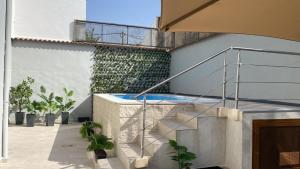 a building with a staircase and a balcony with plants at Los Henares 3 in Olombrada