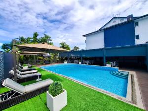 a swimming pool in a yard next to a building at Gazelle International Hotel in Kokopo