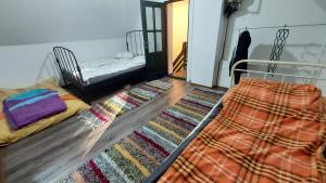 a bedroom with a bed and a rug on the floor at Bori Guest House in Miercurea-Ciuc