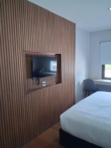 a bedroom with a bed and a tv on a wall at Ma Relax Place in Ban Hau Chang