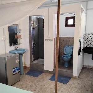a bathroom with a toilet and a sink at Saloon lodge in Antsiranana