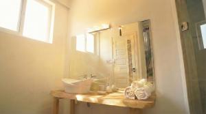 a bathroom with a sink and a mirror at Riad Chama in Essaouira +97 photos