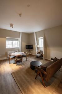 a living room with a couch and a table at ADAM & EVE Paleisstraat in The Hague