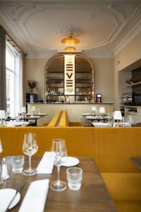 a restaurant with tables and chairs and a bar at ADAM & EVE Paleisstraat in The Hague