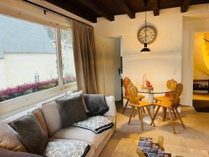 a living room with a couch and a table at Ferienwohnungen Albana in Silvaplana