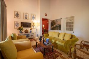 a living room with two couches and a table at Heuvel Villa Kandy in Kandy
