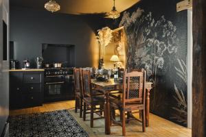 a kitchen with a dining room table and chairs at Old Earth - Ridgestone in Kendal