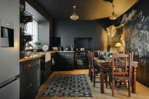 a kitchen with a wooden table and a dining room at Old Earth - Ridgestone in Kendal +53 photos