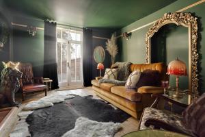 a living room with a couch and a mirror at Old Earth - Ridgestone in Kendal