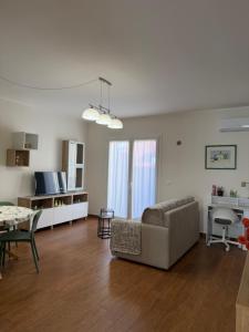 a living room with a couch and a table at Vinaka Etna in Biancavilla