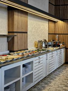 a kitchen with a counter with plates and pans at Akgül Otel in Malatya