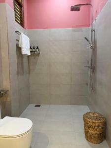 a bathroom with a toilet and a shower at Piña Boutique Hotel - Beachfront in Habaraduwa Central +53 photos