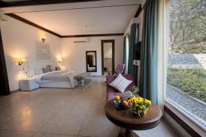 a living room with a bed and a table at Yog Niketan Villa in Rishīkesh +30 photos