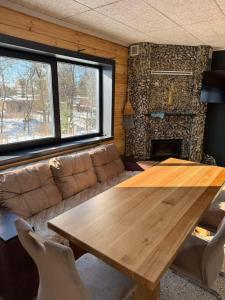 a living room with a wooden table and a couch at Kolyba Club in Stanishovka