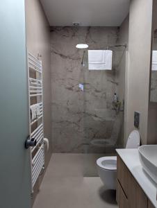 a bathroom with a shower and a toilet and a sink at Ekavis House and Terrace in Kavála