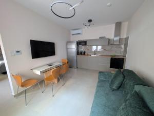 a living room with a couch and a table and a kitchen at Ekavis House and Terrace in Kavála +8 photos