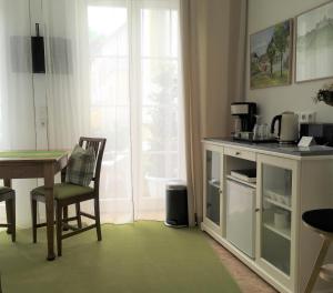 a kitchen with a table and a table and a window at Wanderer und Radlerzimmer in Lieser