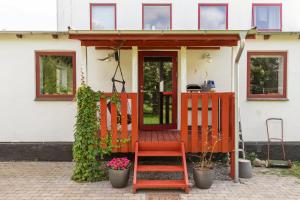 a red chair sitting in front of a house at Mårslet - close to ocean and city in Mårslet +2 photos
