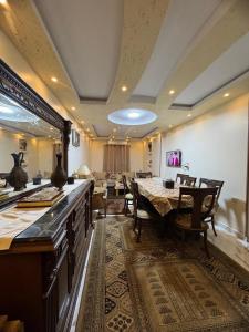a dining room with a table and some chairs at Giza - faisal in Cairo