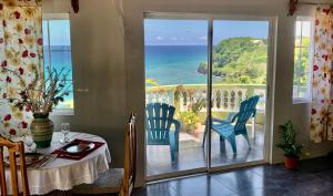a dining room with a view of the ocean at I VIEW - in Long Bay in Long Bay Village
