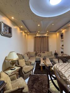 a large living room with couches and a tv at Giza - faisal in Cairo