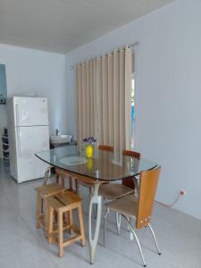 a dining room with a glass table and chairs at Blue Beach Villa Anyer in Pasauran