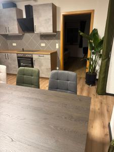 a kitchen with two chairs and a table at Moderne große Wohnung mit Garten in Hausham