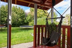 a hammock hanging on a porch with a table at Mårslet - close to ocean and city in Mårslet