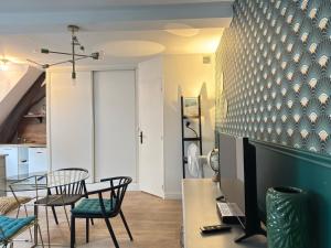 a living room with a table and chairs at Rempart Doré in Saint Malo