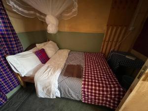 a small bed in a small room with at Mara oasis in Mara Simba +7 photos