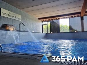 a water fountain in a swimming pool in a building at 365PAM - Apartament nr 32 w Mielenku - BASEN KRYTY, ANIMACJE DLA DZIECI, JACUZZI, SAUNA,PLAC ZABAW W CENIE in Mielenko