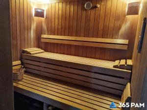 a sauna with two benches in a wooden room at 365PAM - Apartament nr 32 w Mielenku - BASEN KRYTY, ANIMACJE DLA DZIECI, JACUZZI, SAUNA,PLAC ZABAW W CENIE in Mielenko +31 photos