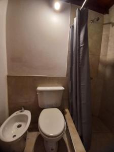 a small bathroom with a toilet and a sink at Tere & Tino Cabañas in Río Ceballos +42 photos