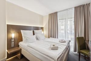 a hotel room with a large bed and a window at Cityhotel Amadeus - 3 Sterne Superior in Münster +50 photos