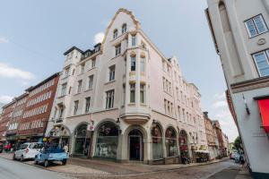 a large white building on a city street at Apartment Josephine in Lübeck