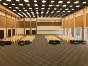 an empty lecture hall with chairs and a stage at Firefox Hotel and Resort in Moinabad