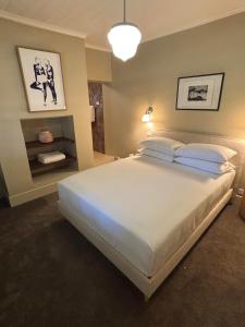 a bedroom with a large white bed in it at Bathurst River House B & B in Bathurst