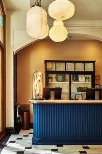 a blue bar in a restaurant with chandeliers at King Street Townhouse Hotel & Spa in Manchester