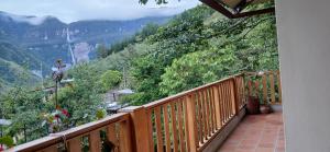 a wooden balcony with a view of a mountain at Gocta Miradors Deluxe in Cocachimba