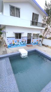 a house with a swimming pool in front of a house at 3BHK - Bamboo Private Pool Villa Yercaud in Yercaud