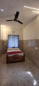 a bedroom with a bed with a ceiling fan at 3BHK - Bamboo Private Pool Villa Yercaud in Yercaud +9 photos