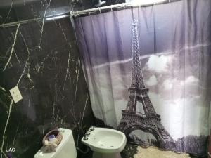 a bathroom with a shower curtain with the eiffel tower at Los del Sur cabañas in Comodoro Rivadavia