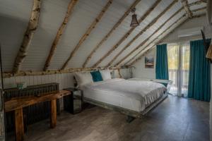 a bedroom with a bed and a table in it at Bârlogul Vikingilor in Şotrile