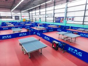 a room with several tables in it with blue tables at Firefox Hotel and Resort in Moinabad +11 photos