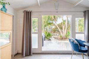 a living room with a sliding glass door at Secret Garden Chalet No. 1 in San Pietro in Bevagna