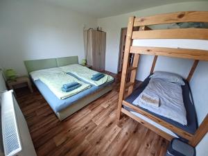 a bedroom with two bunk beds and a television at Chaty Antónia in Hriňová