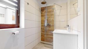 a white bathroom with a shower and a sink at Studio Fibra Choco in Rybnik