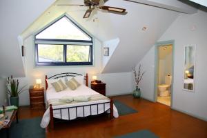 
a bedroom with a bed and a window at Salamander Bay Bed and Breakfast in Salamander Bay
