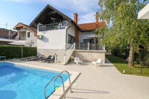 a house with a swimming pool in front of it at Villa Mina Kladovo, 5-Bedroom Villa with Pool for up to 12 People in Kladovo