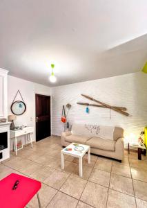 a living room with a couch and a table at Lime Andros Maisonette by HOSTANDROS in Apróvaton